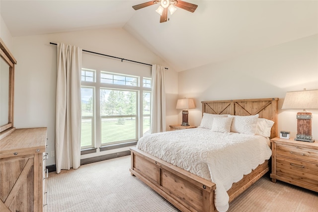 bedroom featuring lofted ceiling, light carpet, and a ceiling fan