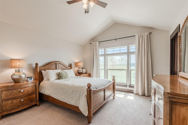 bedroom featuring light carpet, lofted ceiling, and a ceiling fan