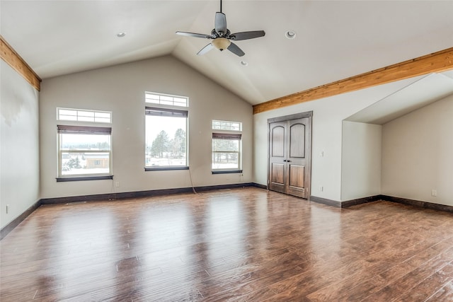 interior space featuring high vaulted ceiling, ceiling fan, baseboards, and wood finished floors