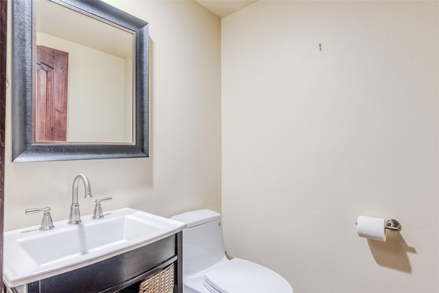 bathroom featuring toilet and vanity