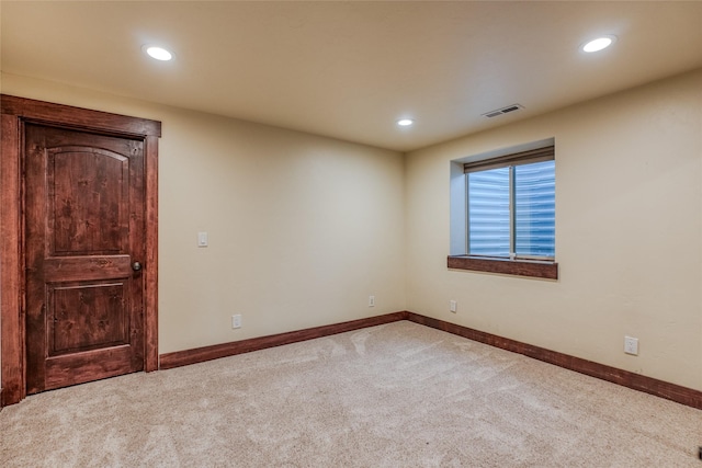 empty room featuring recessed lighting, carpet flooring, visible vents, and baseboards