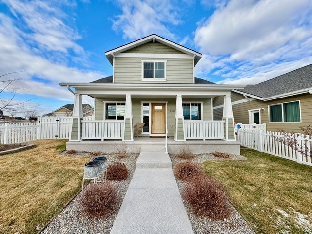 view of front of house with a porch and a front yard