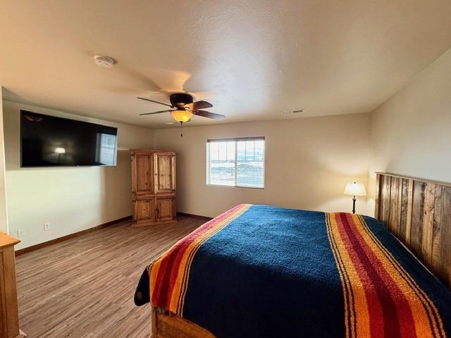 bedroom featuring hardwood / wood-style flooring and ceiling fan