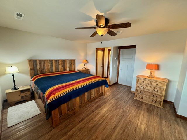 bedroom featuring ceiling fan and dark hardwood / wood-style flooring