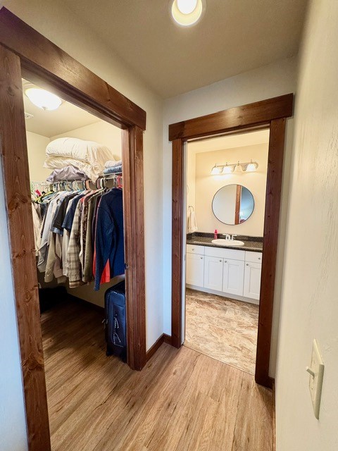 corridor featuring light hardwood / wood-style floors and sink