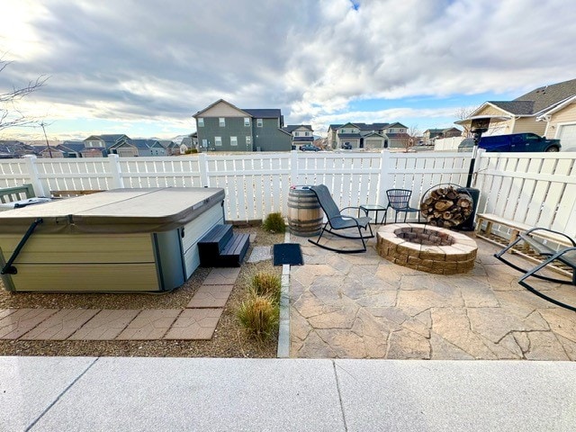 view of patio featuring a fire pit and a hot tub