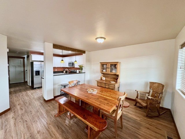 dining area with hardwood / wood-style flooring