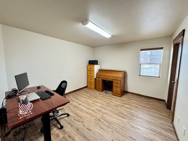 office space with light hardwood / wood-style flooring