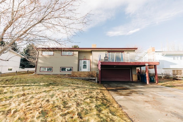 bi-level home featuring a garage, a front lawn, and a wooden deck