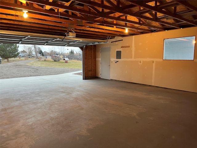 garage featuring electric panel and a garage door opener