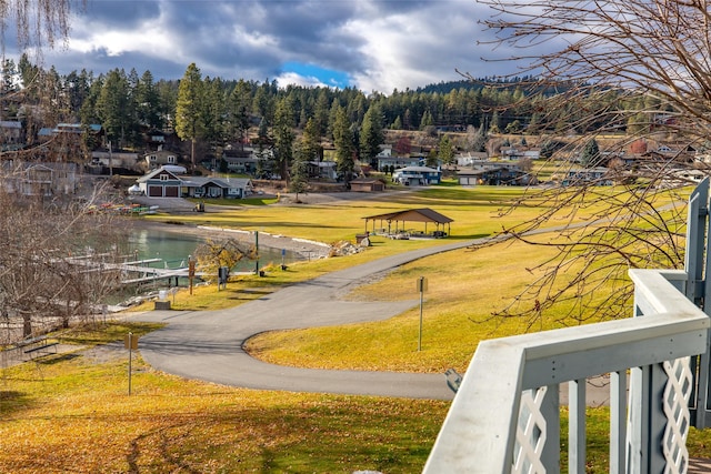 view of home's community featuring a lawn and a water view