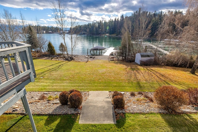 view of yard with a water view and a boat dock