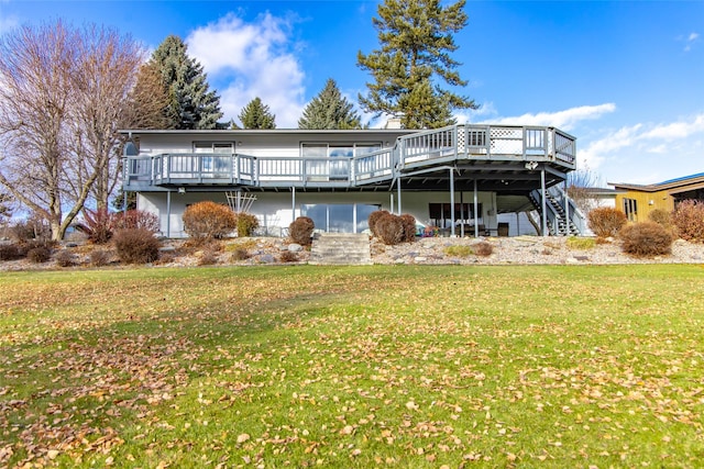 back of property featuring a wooden deck and a yard