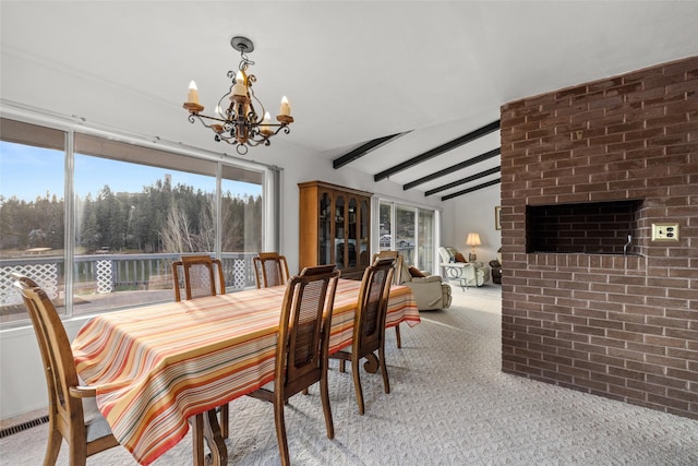 dining space featuring lofted ceiling with beams, light carpet, and a chandelier