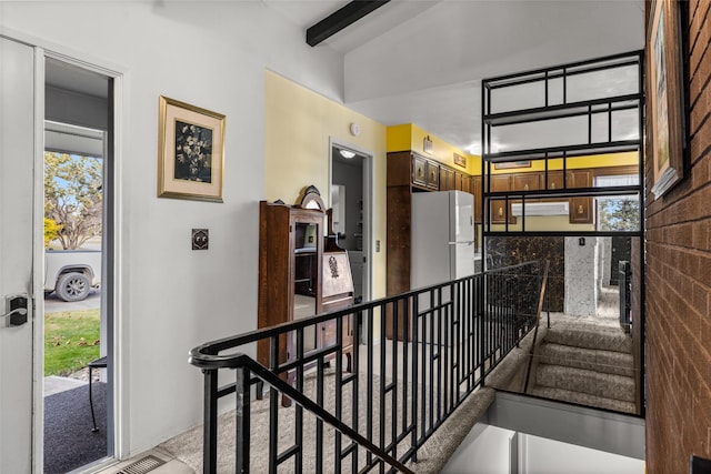 hallway featuring vaulted ceiling with beams