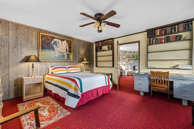 bedroom featuring dark carpet, ceiling fan, and wooden walls