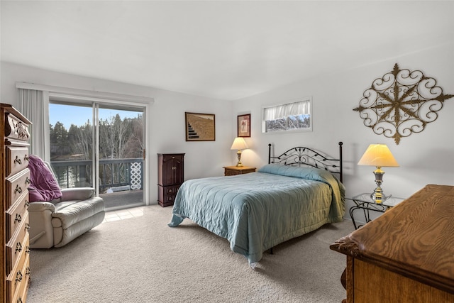 bedroom featuring light colored carpet and access to outside