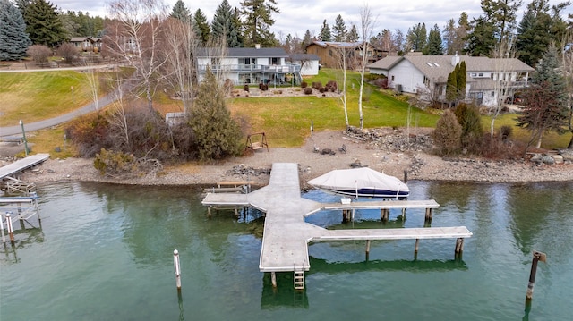 dock area featuring a yard and a water view