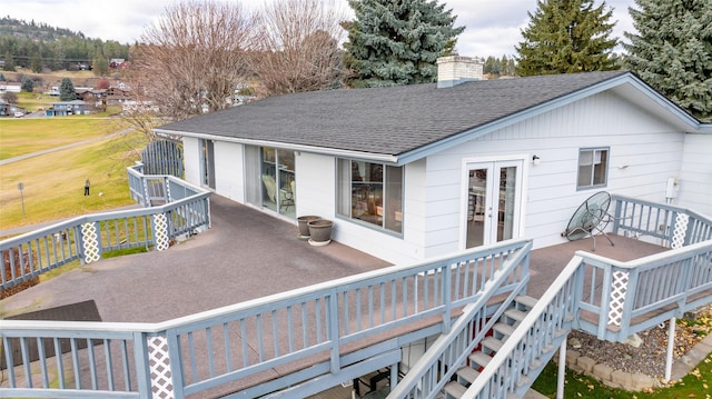 back of house featuring french doors and a wooden deck