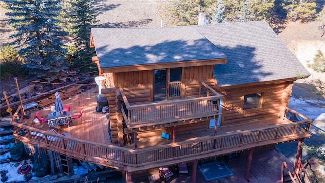 rear view of property with a wooden deck