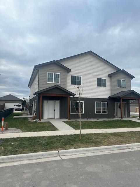 view of front property featuring a garage and a front lawn