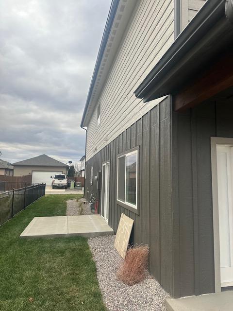 view of side of property with a yard and a patio