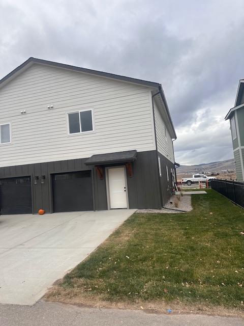 exterior space featuring a garage and a front yard