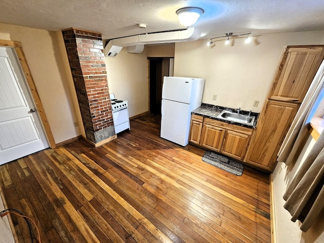 1733 S 11th St W, Missoula, MT 59801 - kitchen featuring white appliances, dark countertops, dark wood finished floors, a sink, and a textured ceiling