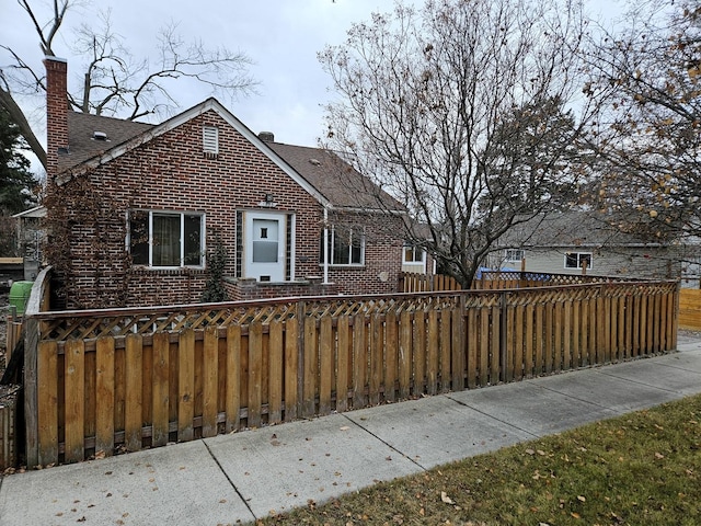 1733 S 11th St W, Missoula, MT 59801 - view of front of property with brick siding, a chimney, and roof with shingles