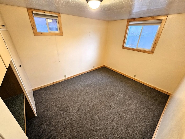 1733 S 11th St W, Missoula, MT 59801 - unfurnished bedroom with a textured ceiling, baseboards, and dark carpet