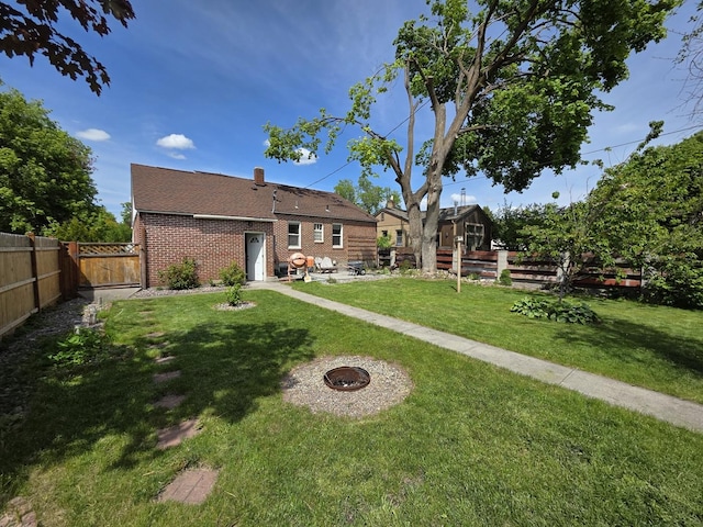 1733 S 11th St W, Missoula, MT 59801 - back of property featuring brick siding, a patio, and a gate