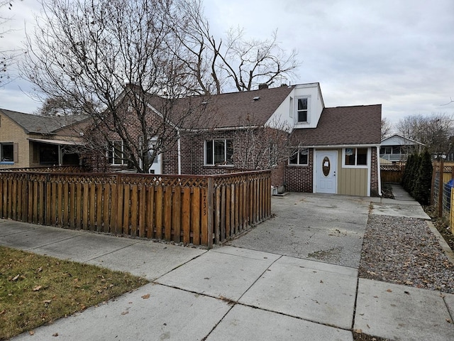 1733 S 11th St W, Missoula, MT 59801 - view of front of home with driveway, brick siding, and a shingled roof