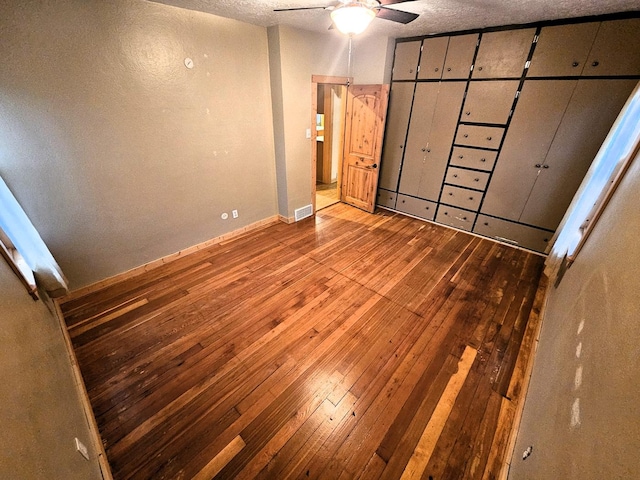 1733 S 11th St W, Missoula, MT 59801 - unfurnished bedroom with hardwood / wood-style floors, baseboards, and a textured ceiling