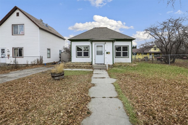 bungalow-style house with a front lawn