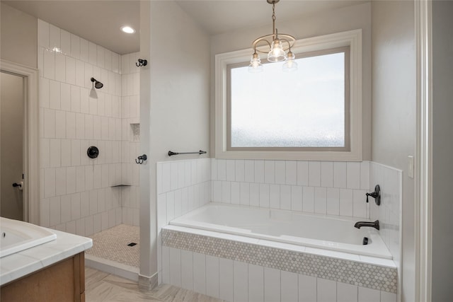 bathroom featuring plus walk in shower and an inviting chandelier