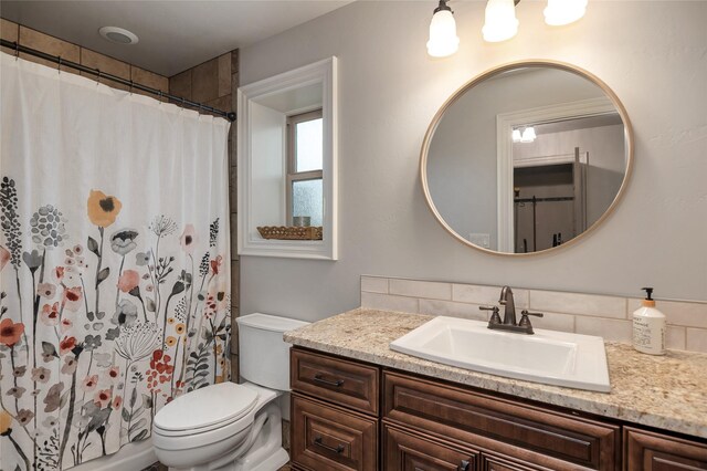 bathroom with vanity, toilet, and walk in shower