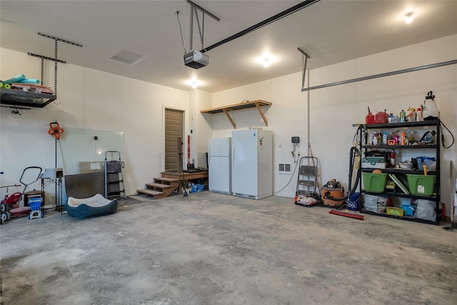 garage with white fridge and a garage door opener