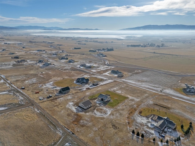 birds eye view of property with a mountain view and a rural view