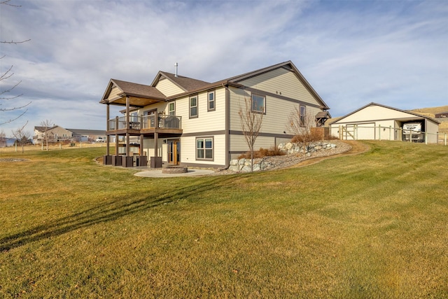 back of property featuring a yard, a fire pit, a patio area, and a wooden deck