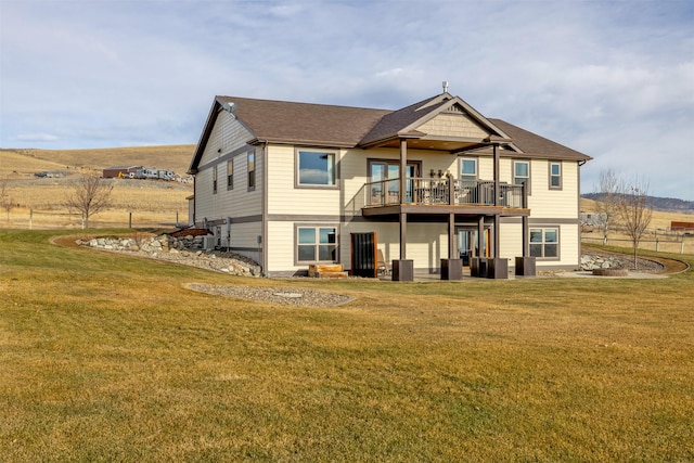 back of property featuring a yard and a wooden deck