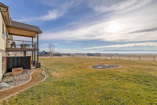 view of yard featuring a rural view and a balcony