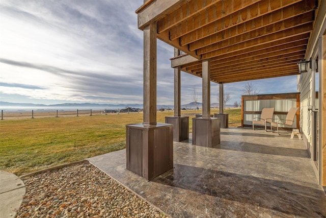 view of patio / terrace with a mountain view and a rural view