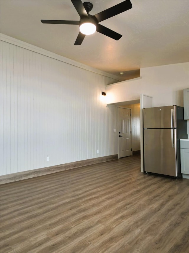 unfurnished living room with hardwood / wood-style flooring and ceiling fan