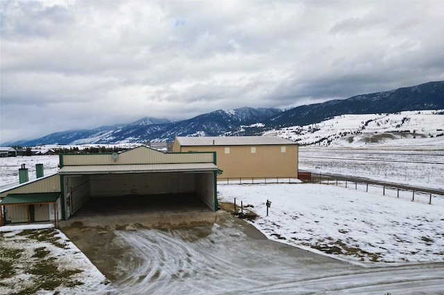 snow covered property featuring a mountain view