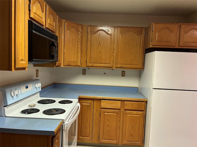 kitchen with backsplash and white appliances