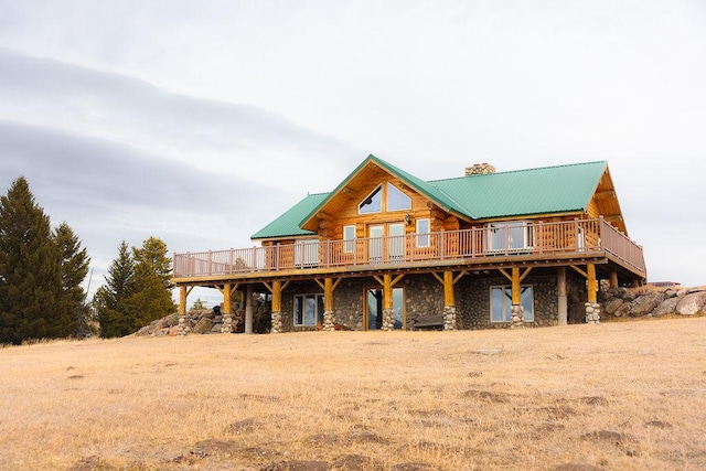 log home with a wooden deck