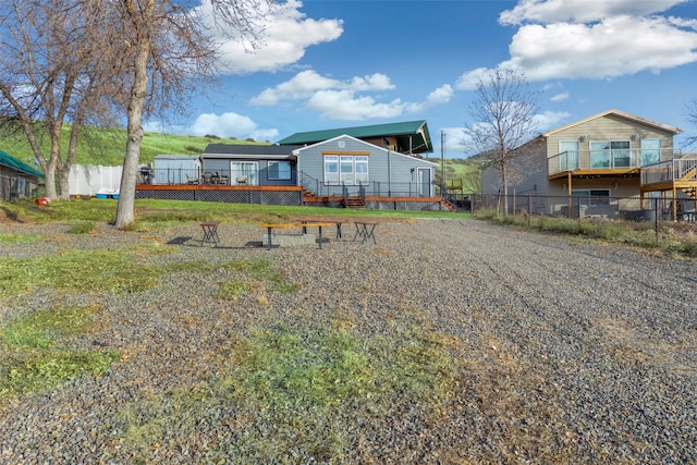 rear view of house featuring a deck