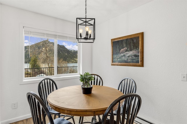 dining room with hardwood / wood-style floors and a chandelier