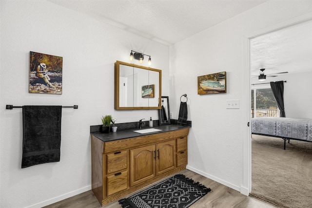 bathroom with vanity, hardwood / wood-style flooring, and ceiling fan