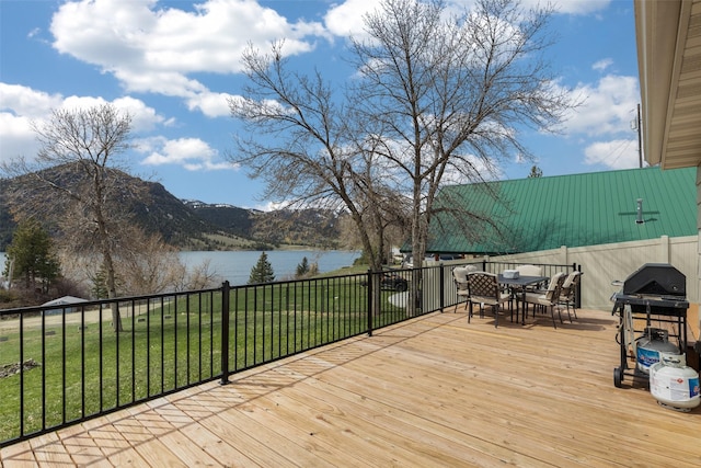 deck featuring a yard and a water and mountain view